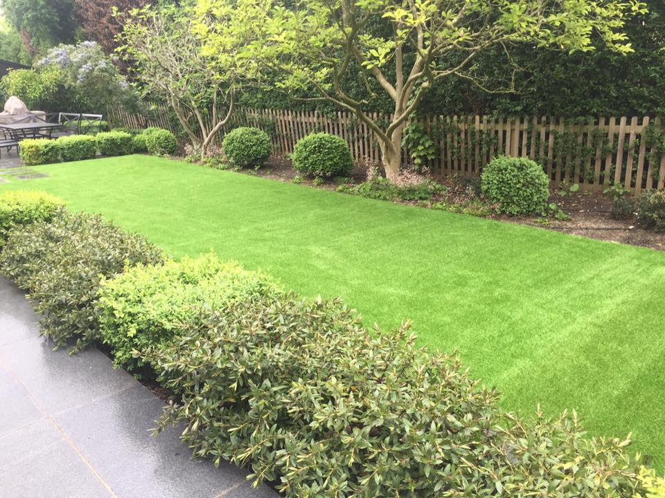 artificial lawn installed next to driveway